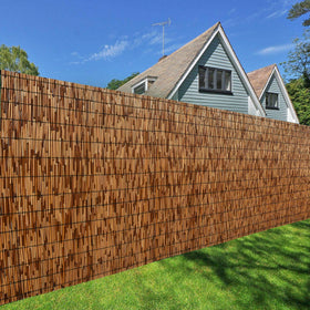 DearHouse reed fence weathered look blends with exterior environments.