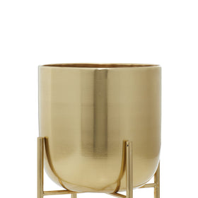 Removable stands on Deco 79 planters show curved X bases.