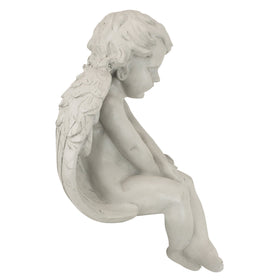 Design Toscano Angel sitting on books adds quiet ambiance.