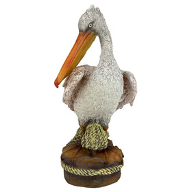 Design Toscano pelican statue, wood pilings detail—adds seaside charm to garden or patio.