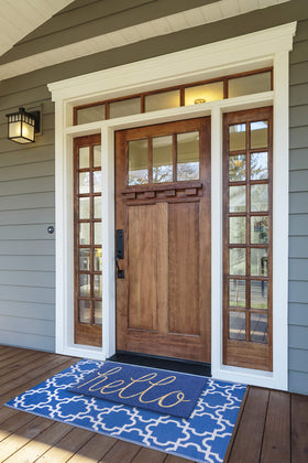 DII Hello Coir Fiber Doormat, non-slip backing visible on blue floor