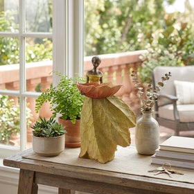 DiliComing yellow garden statue doubles as a decorative bird-feeder accent.