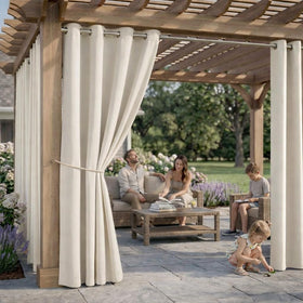 DIVA EN CAMINO DEC cream curtain serving as a privacy divider on a patio.