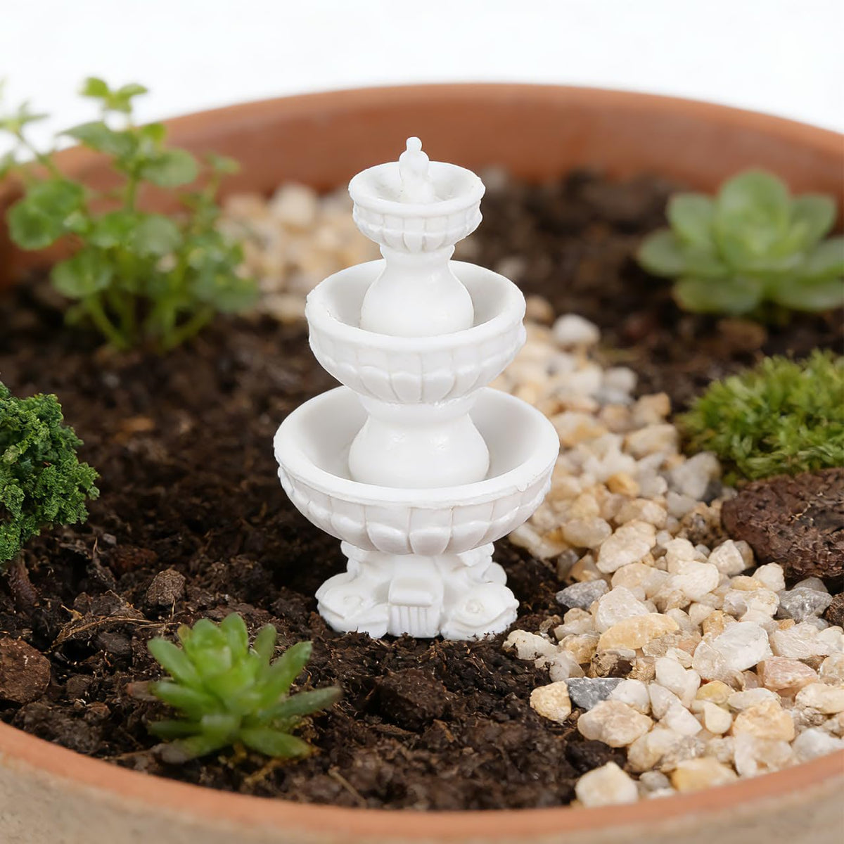 DOITOOL tiered fountain ornament anchors small garden scenes with quiet elegance