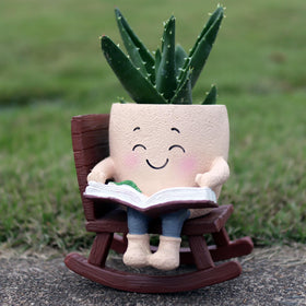 Dolkgy cute head planter on rocking chair adds whimsy to indoor plant decor