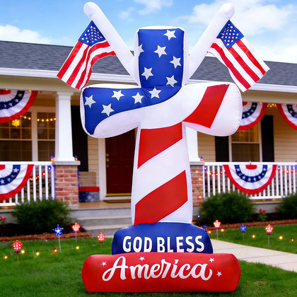DomKom patriotic cross inflatable with American flags glowing for outdoor celebrations.
