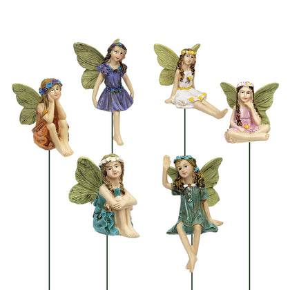 Dorlotou Fairy Garden figurine with blue wings adds whimsy to outdoor spaces.