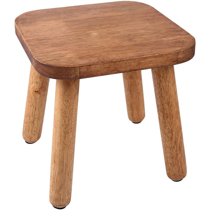 Dovesail walnut finish wooden stool used as a stable plant stand in a cozy living room