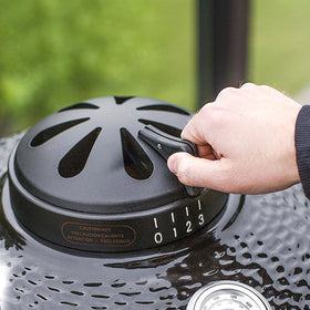 Dracarys charcoal kamado top vent chimney on Vision Grills 18-inch for precise airflow.