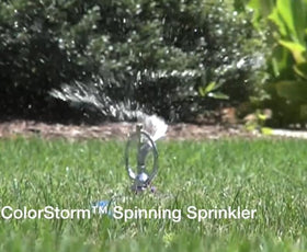 Dramm ColorStorm green sprinkler rests on a heavy base for stable watering.