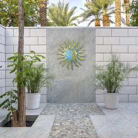 Dreamskip 3D sun wall decor in metal adds texture and depth.
