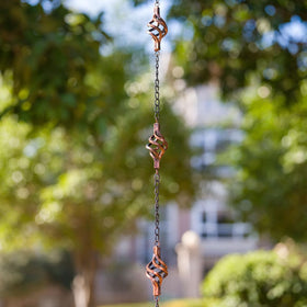 Dreamysoul decorative rain chain doubles as garden art while channeling rain along a crystal path.
