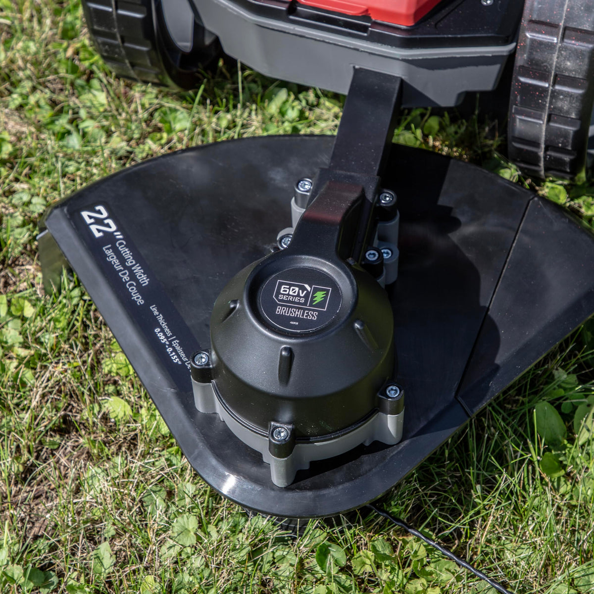 Earthquake 60V mower offset cutting head reaches along fences and edges.