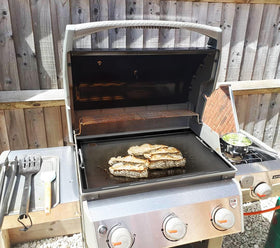 Sizzling steaks on EasiBBQ griddle demonstrating high-heat capability.