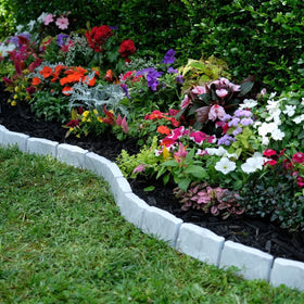 EasyFlex border installed on landscape fabric reduces weed growth in beds.