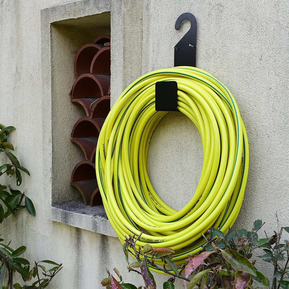 Ebliiny multi-use holder stores hoses, cords, tools.