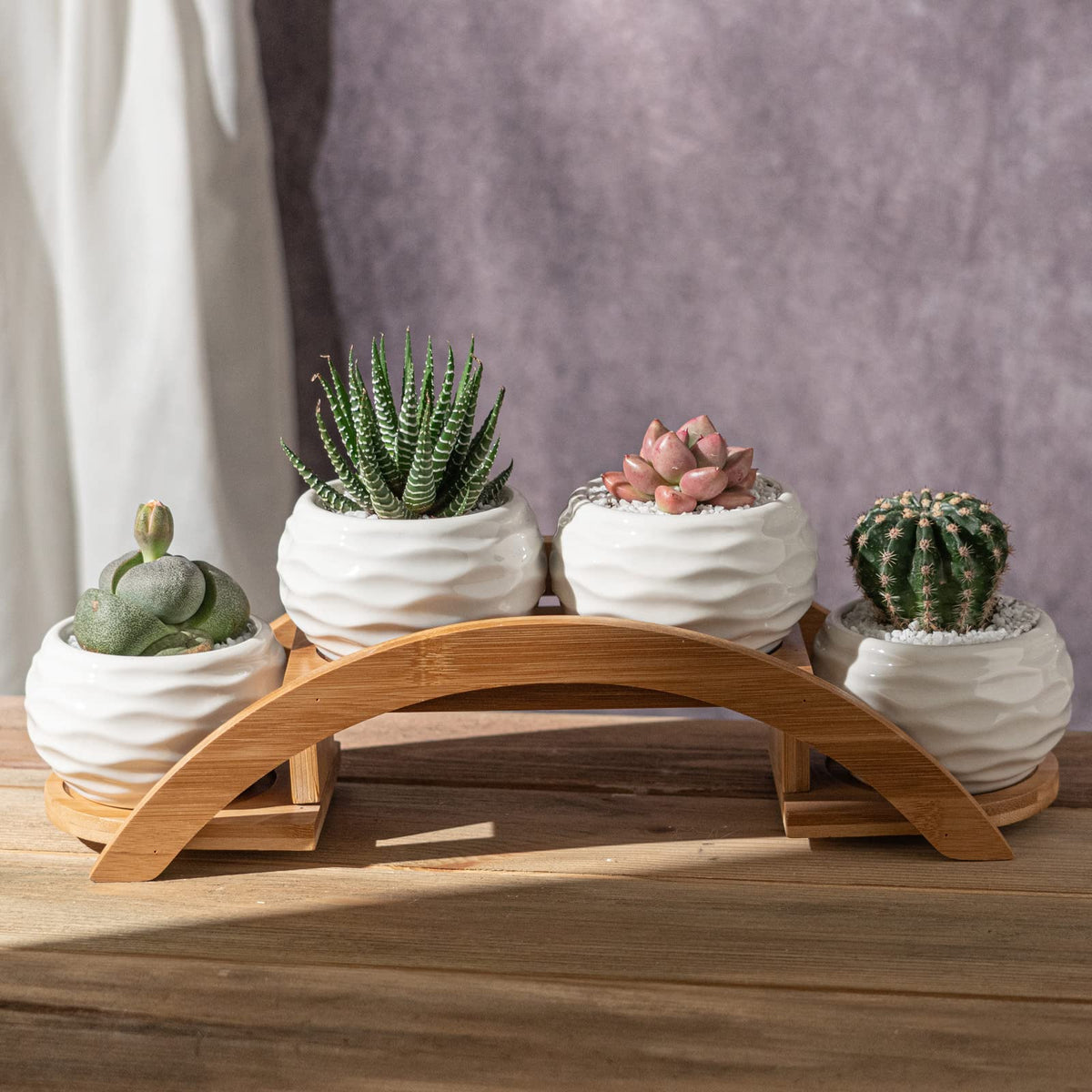 E-liu bamboo arch stand elevates the pots with a natural, elegant frame