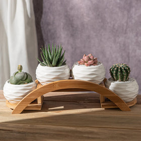 E-liu bamboo arch stand elevates the pots with a natural, elegant frame
