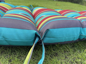 Enipate cushion with fabric ties and back band keeps fabric neat