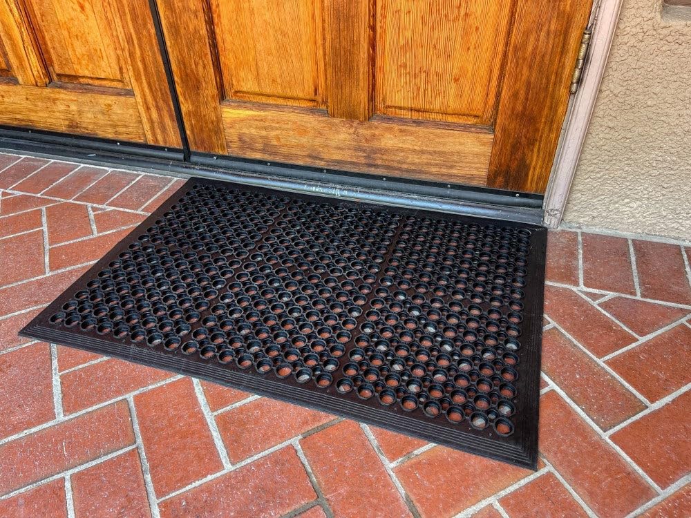 Envelor four-pack mat in garage/workspace, great for durability and drainage in busy areas