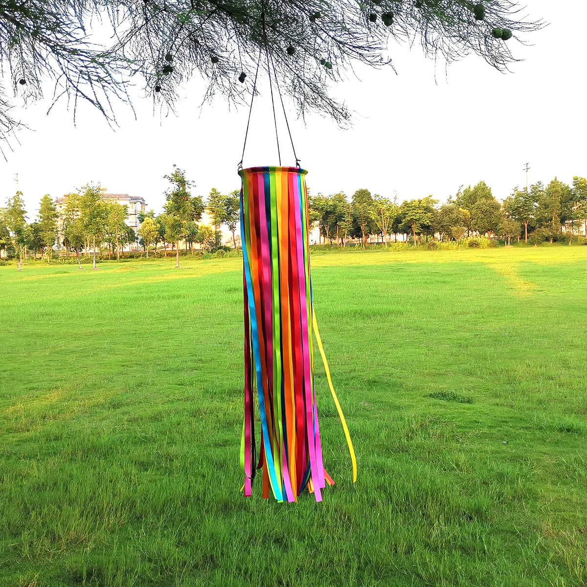 EONBES satin windsock in yellow catches sunlight for a sunny outdoor vibe.