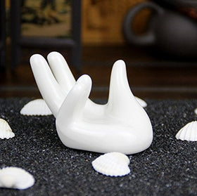 Close-up of Eshylala ceramic hand-shaped air plant holder highlighting smooth finish.