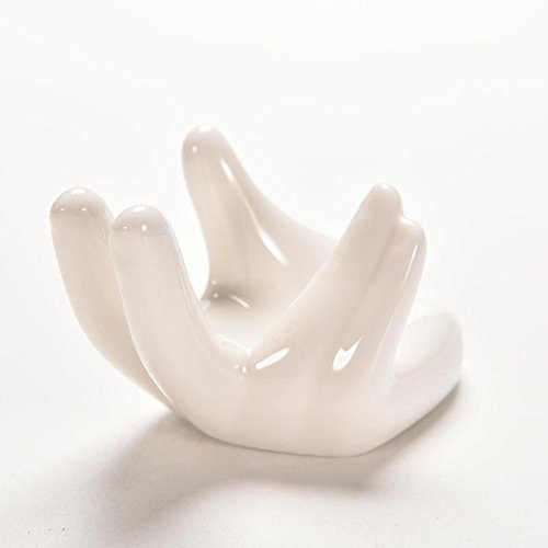 White ceramic hand-shaped stand showcasing tiny plants for compact rooms.