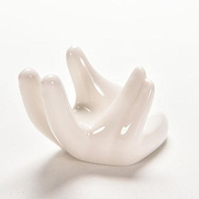 White ceramic hand-shaped stand showcasing tiny plants for compact rooms.