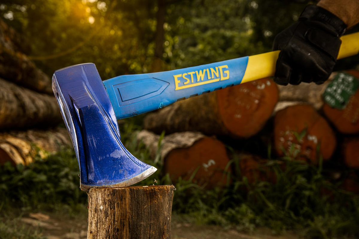 Estwing axe chopping firewood outdoors with steady leverage and control.
