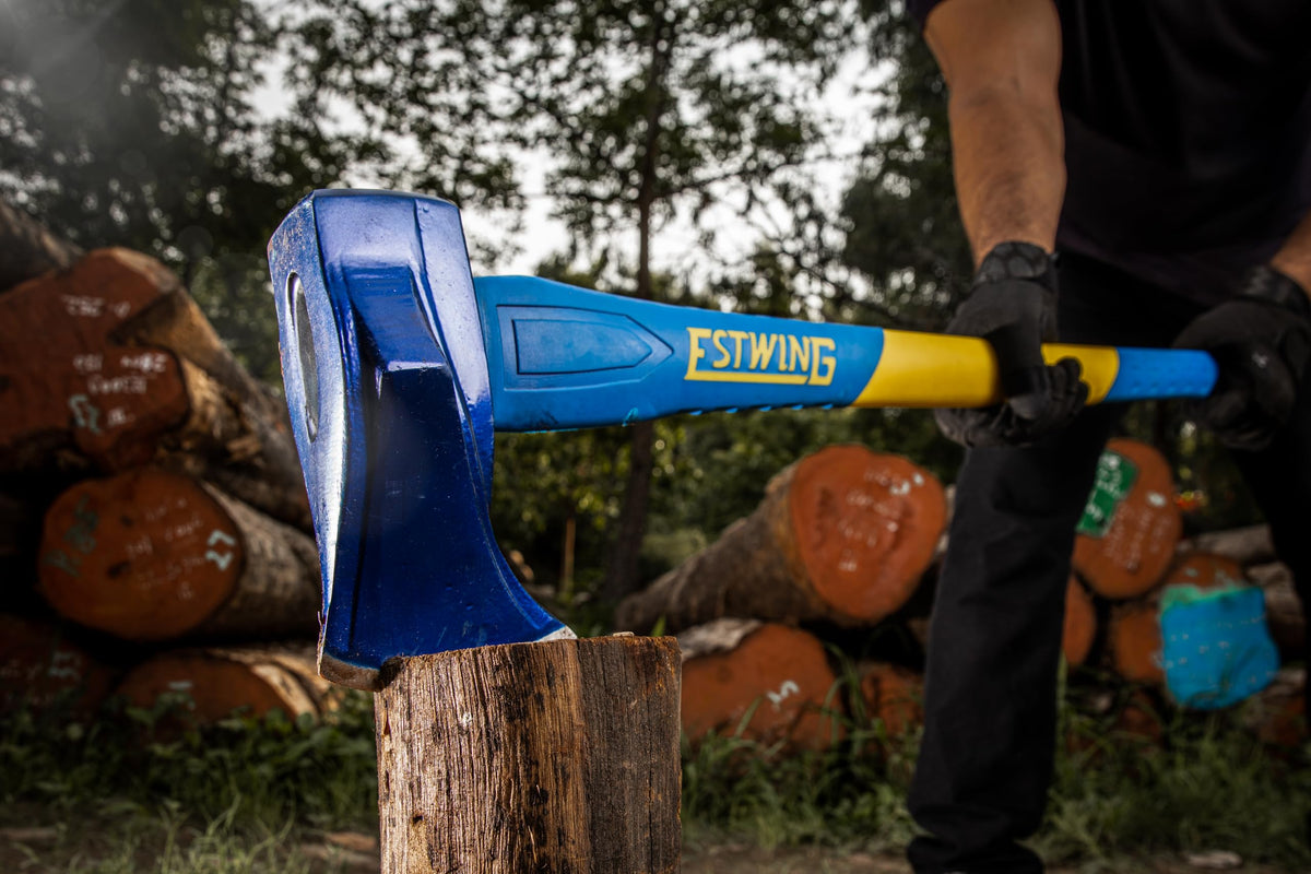 Estwing axe cutting lumber with precision and efficiency in a workshop setting.
