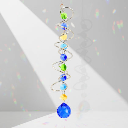 Evechole blue crystal ball with prism and octagonal crystals reflects rainbow light on windows