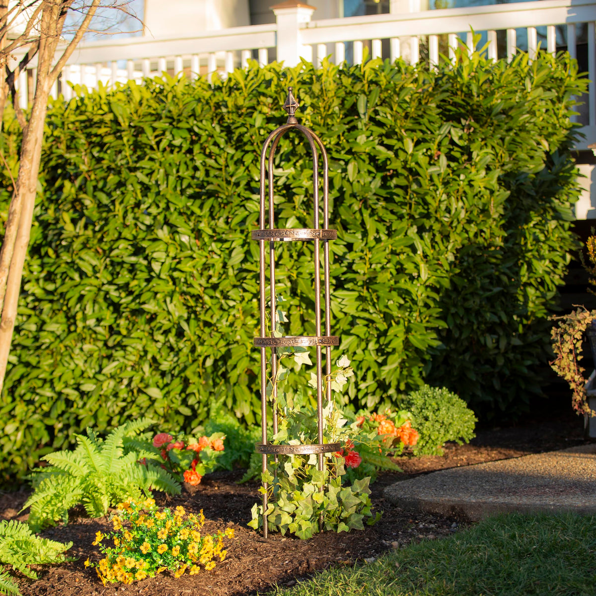 Floral pattern detail on Evergreen Garden obelisk guiding climbing vines