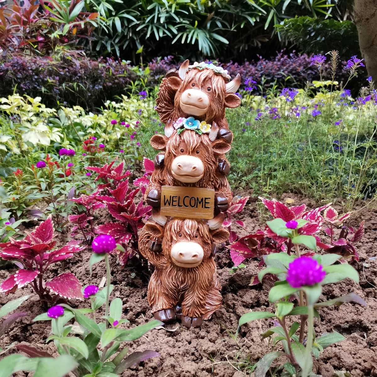 Evursua Highland Cow fairy garden scene adds whimsy to outdoor spaces.