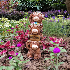 Evursua Highland Cow fairy garden scene adds whimsy to outdoor spaces.