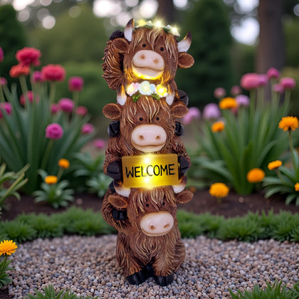 Evursua Highland Cow solar statue with welcome board lights up outdoor entrances.