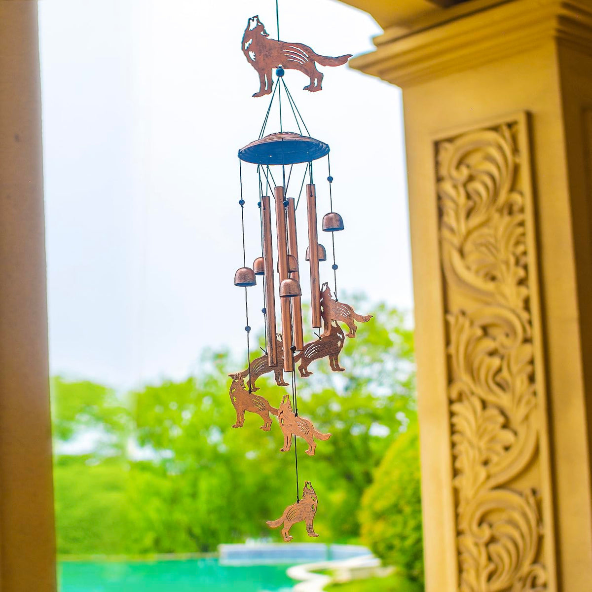 EZTZEN Wolf wind chimes backlit at sunset enhance outdoor decor.