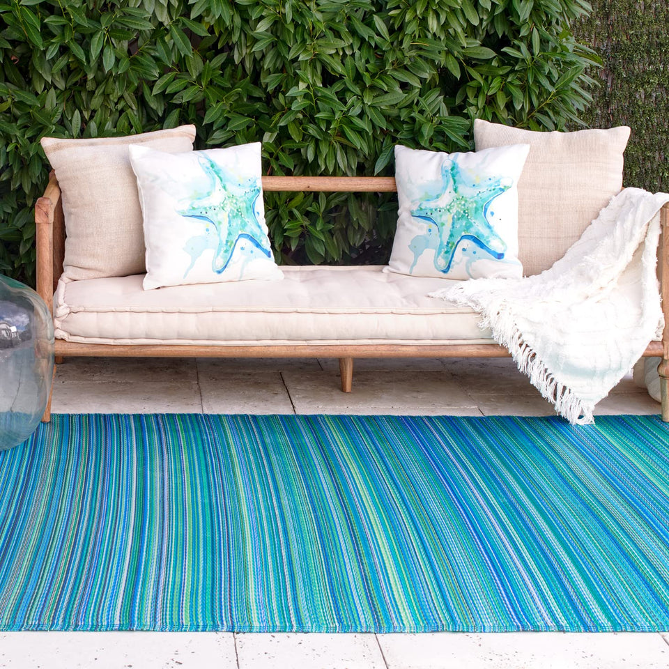 Fab Habitat Cancun stripe outdoor rug on a sunny patio adds vibrant color and style.