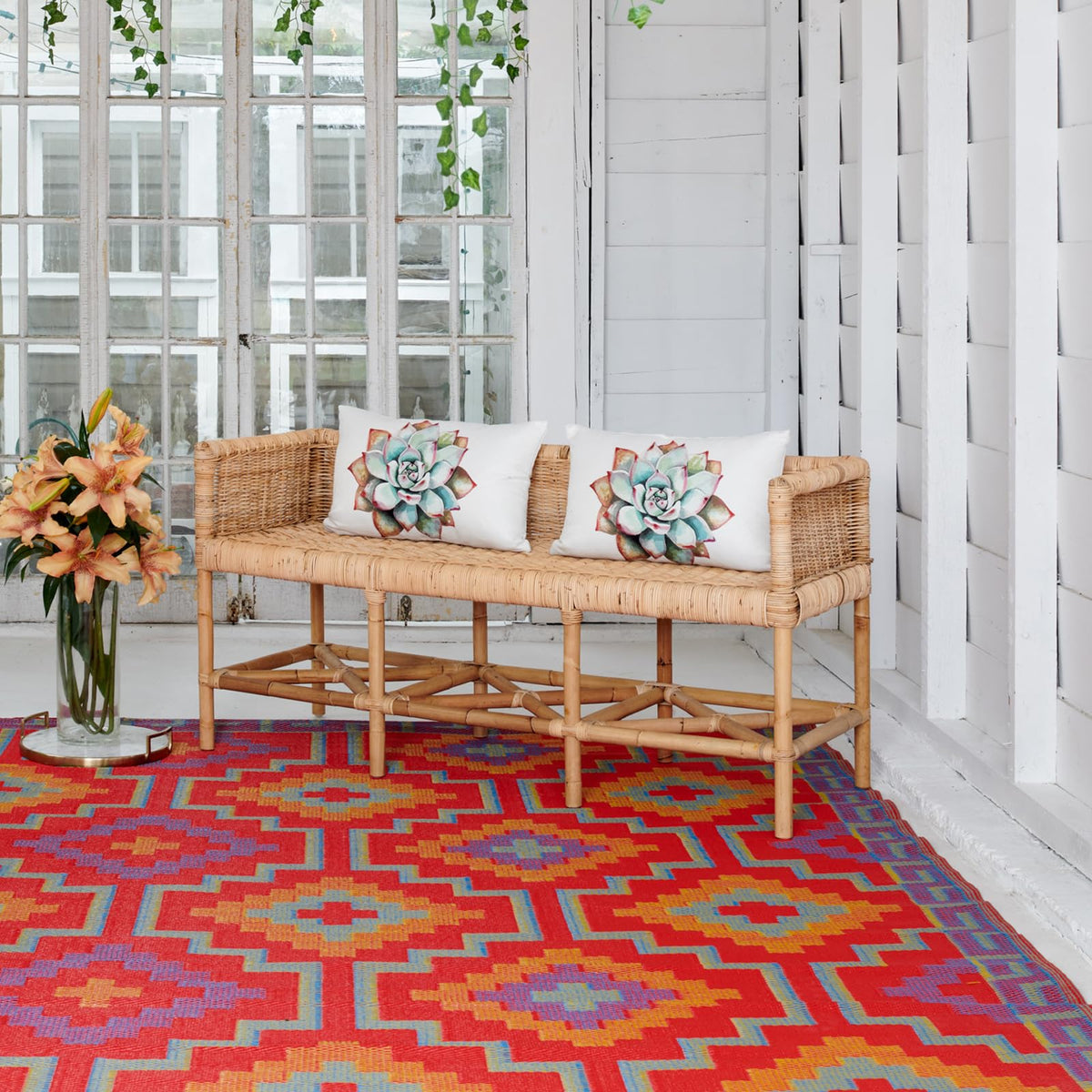 Fab Habitat Lhasa outdoor rug in orange and violet on a patio, waterproof and two-tone