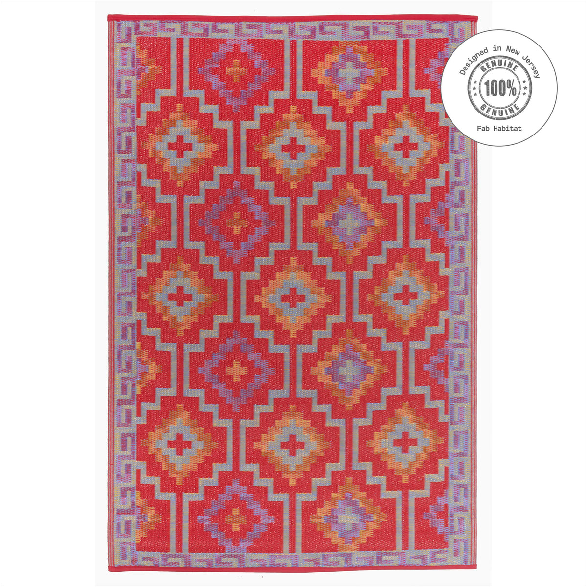 Fab Habitat waterproof outdoor rug shown with hose for cleaning