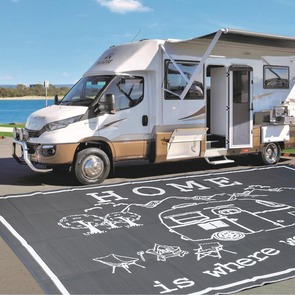 FACOYANS 9x12 outdoor rug laid out on the beach space for a family gathering.
