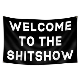 FAMXAKAFLY Shitshow flag hangs in a dorm room, adding playful energy.