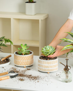 Fayoula planters with elevated feet protect surfaces and keep moisture away.
