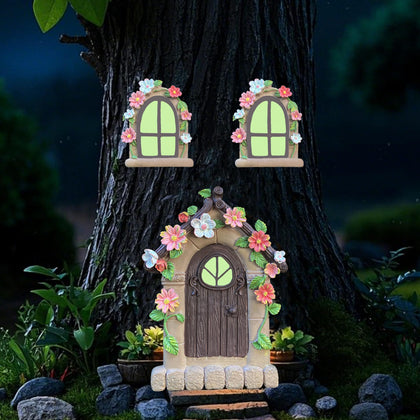 FESTGLOX fairy door on a tree trunk glows softly at night, guiding pixies home.