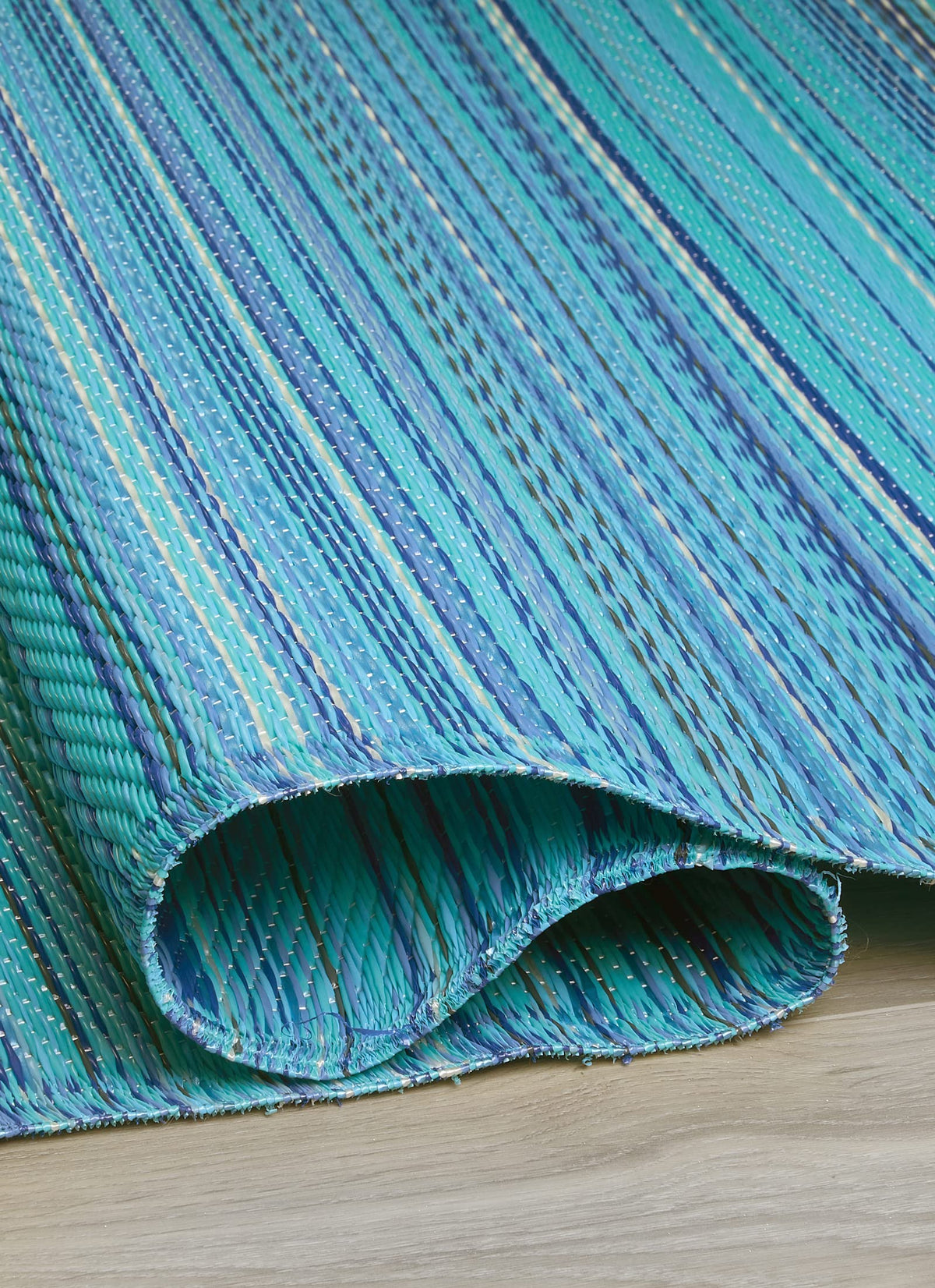 FH Home Havana turquoise rug laid on a patio deck for outdoor dining.