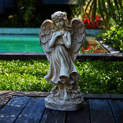 Floryden garden angel figurine outdoors adds serene ambiance to any yard.