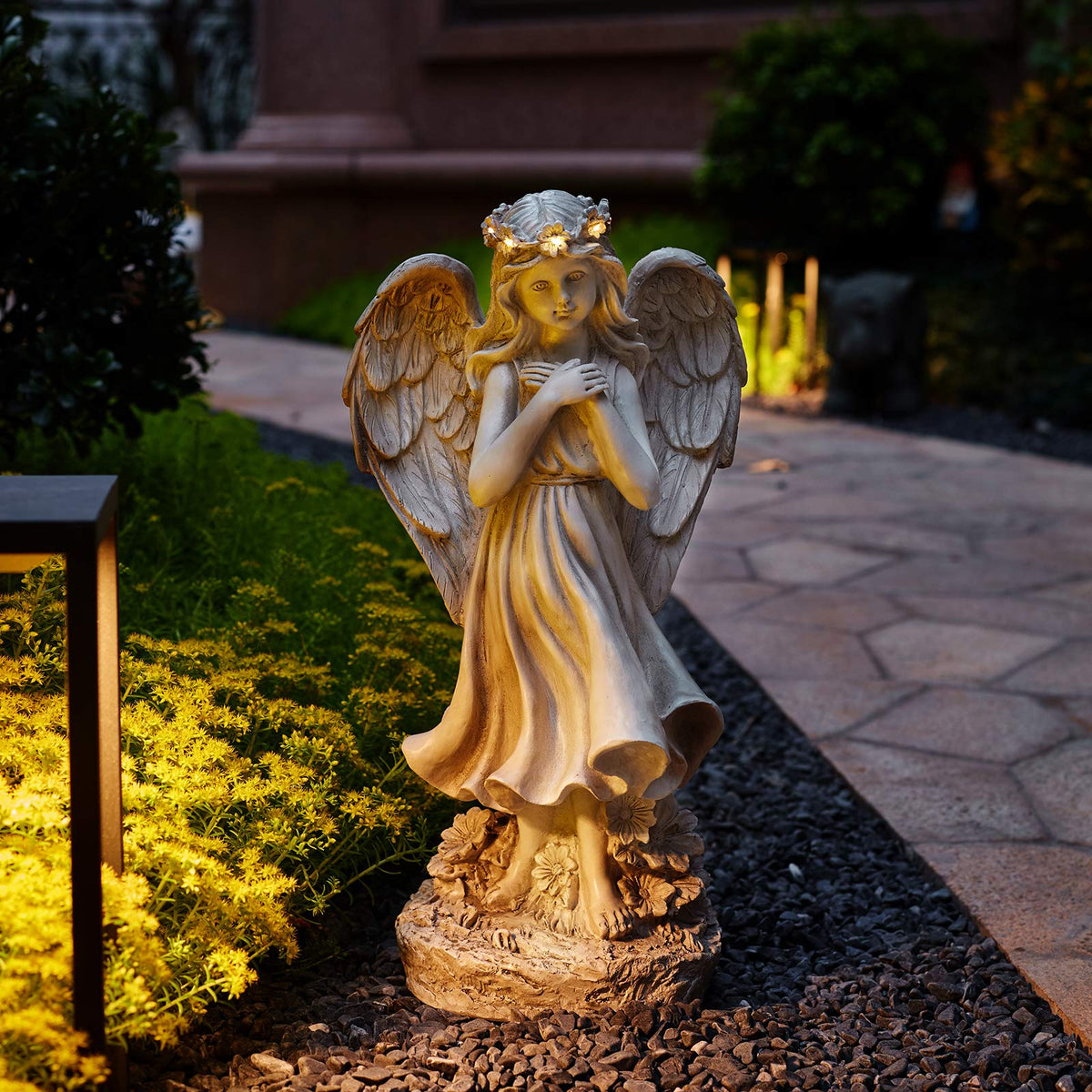 Floryden patio garden angel decoration provides warm evening glow.