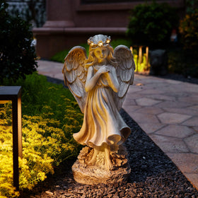 Floryden patio garden angel decoration provides warm evening glow.