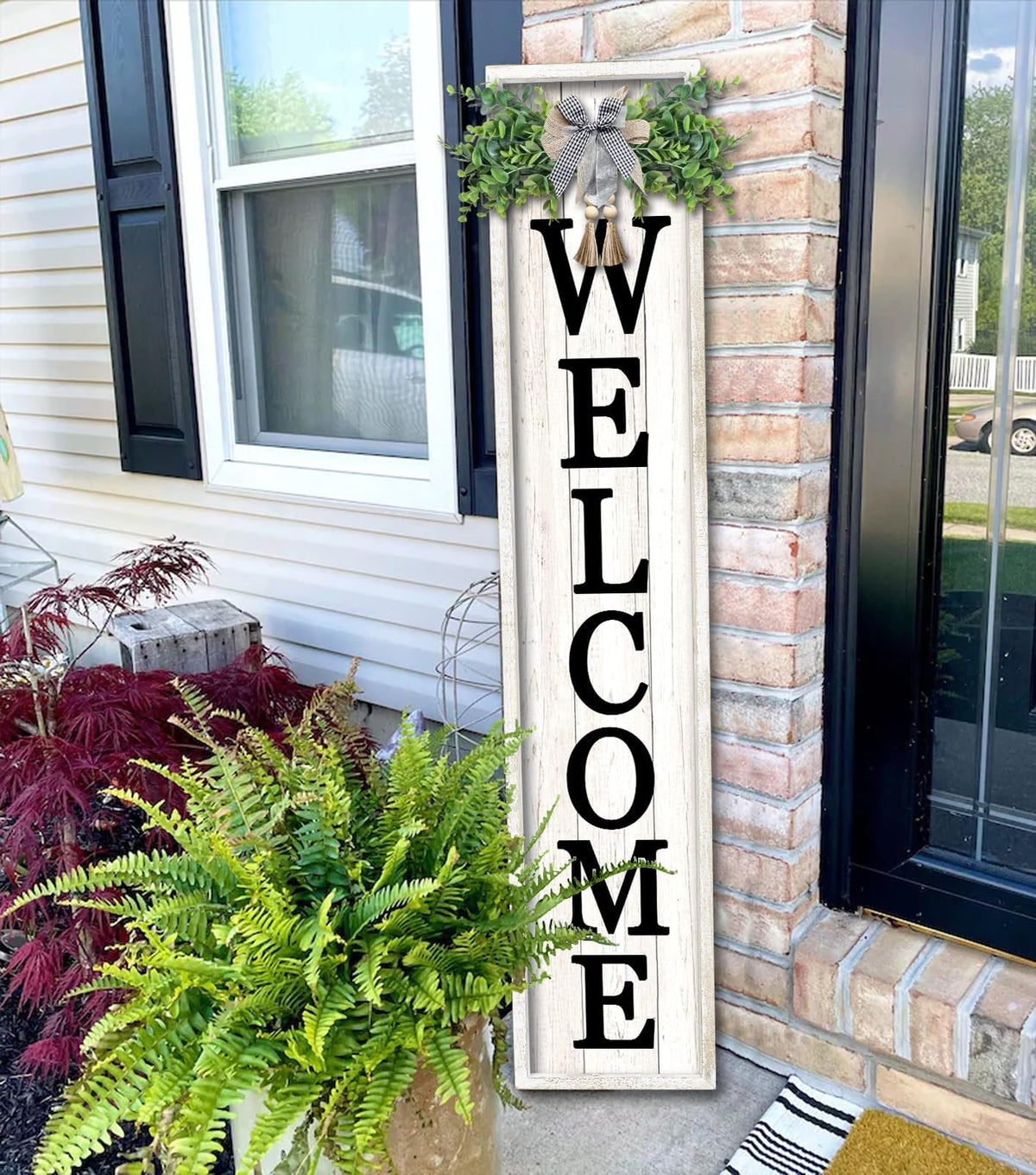 Flowtorely sign shown hanging or leaning beside the front door.