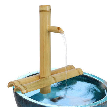 Foci Cozi bamboo fountain spout close-up with natural grain and calming flow.