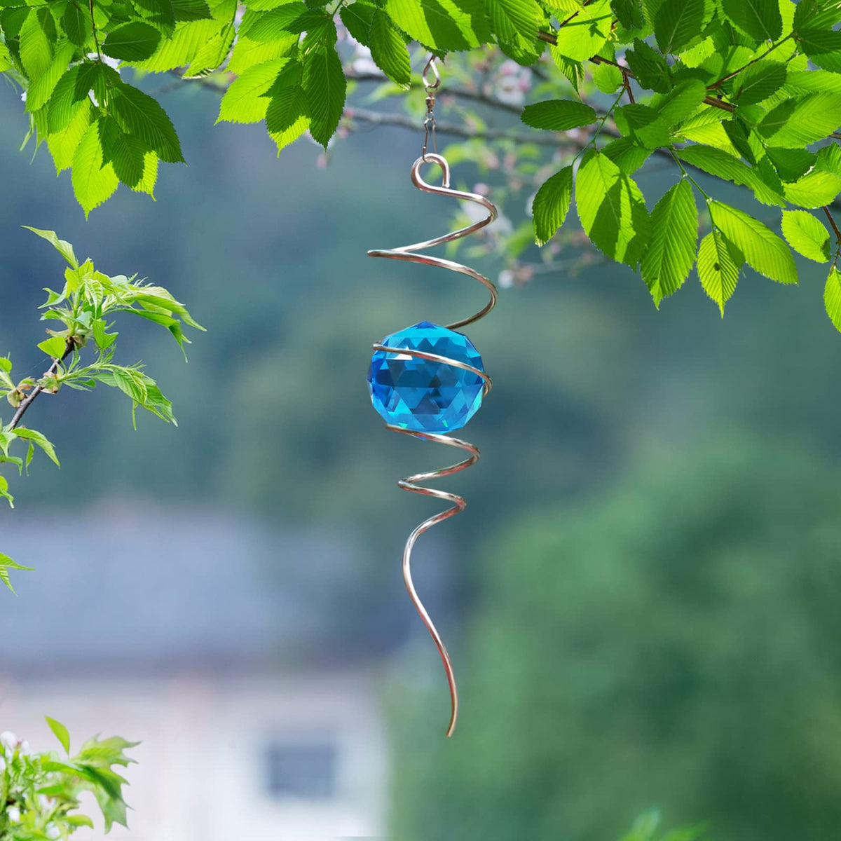 FONMY Peacock blue crystal orb casts vivid rainbows in sun